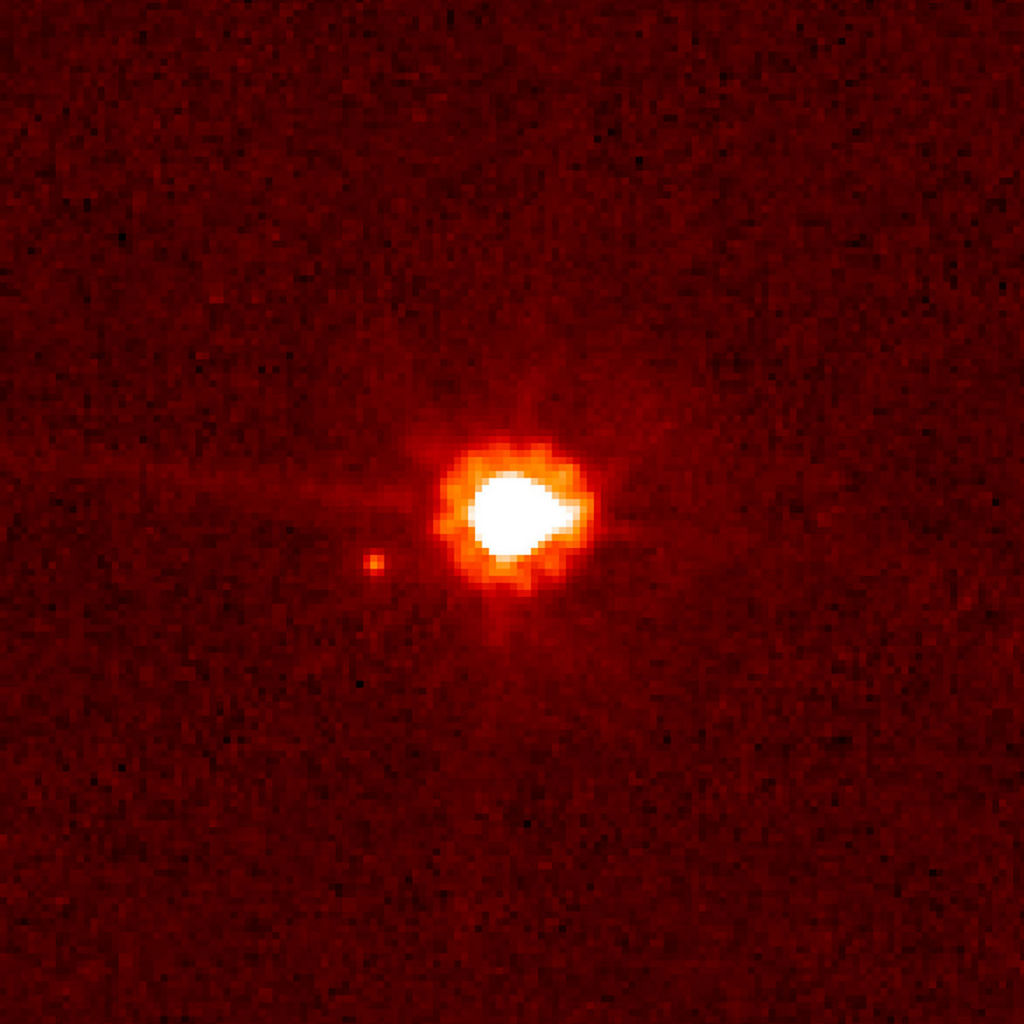 Deze afbeelding, gemaakt met de Hubble-ruimtetelescoop van NASA/ESA op 30 augustus 2006, toont de dwergplaneet Eris (midden) en zijn maan Dysnomia.